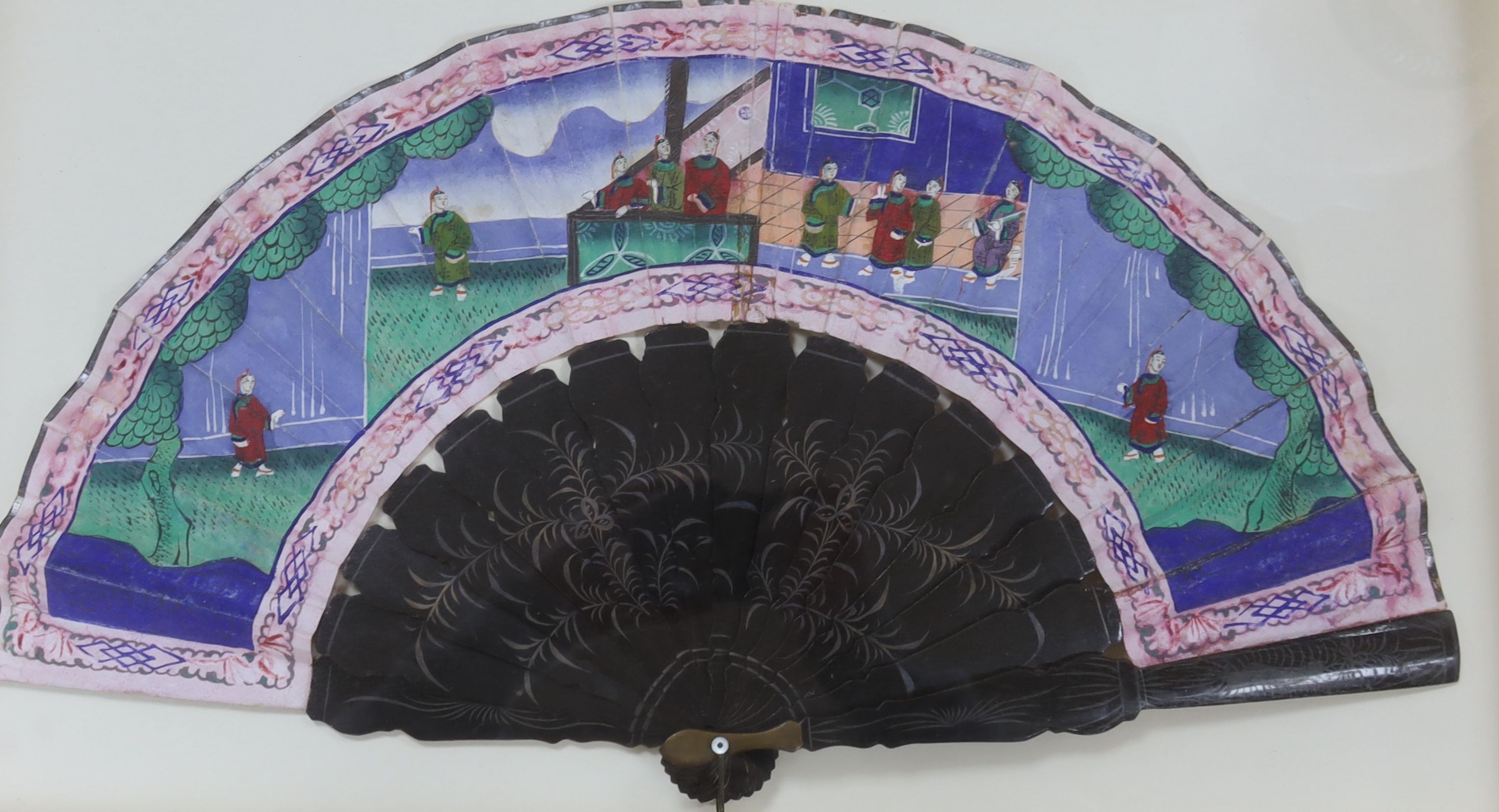 Two Chinese export painted leaf fans, 19th century, one with carved sandalwood guards and sticks, the other with black lacquer, largest case 39 x 63cm